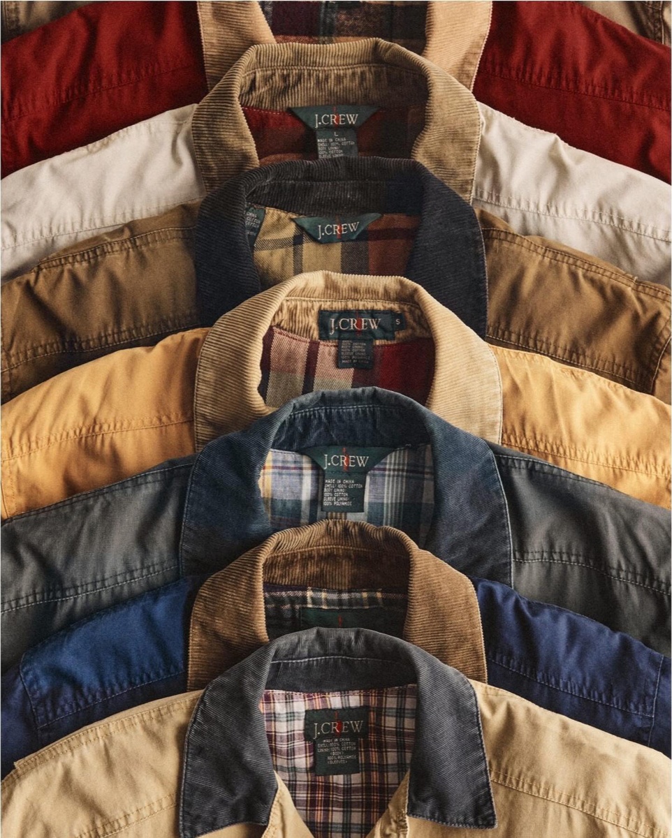 Seven vintage J.Crew barn jackets stacked collar over collar, each with a corduroy collar and plaid flannel lining, in red, cream, khaki, mustard, gray and navy