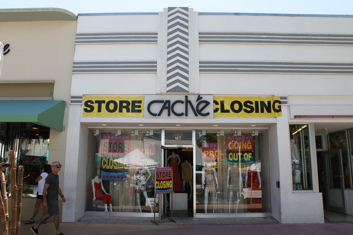 Cache storefront on Lincoln Road with yellow Store Closing banners flanking the logo and mannequins in dresses in the windows
