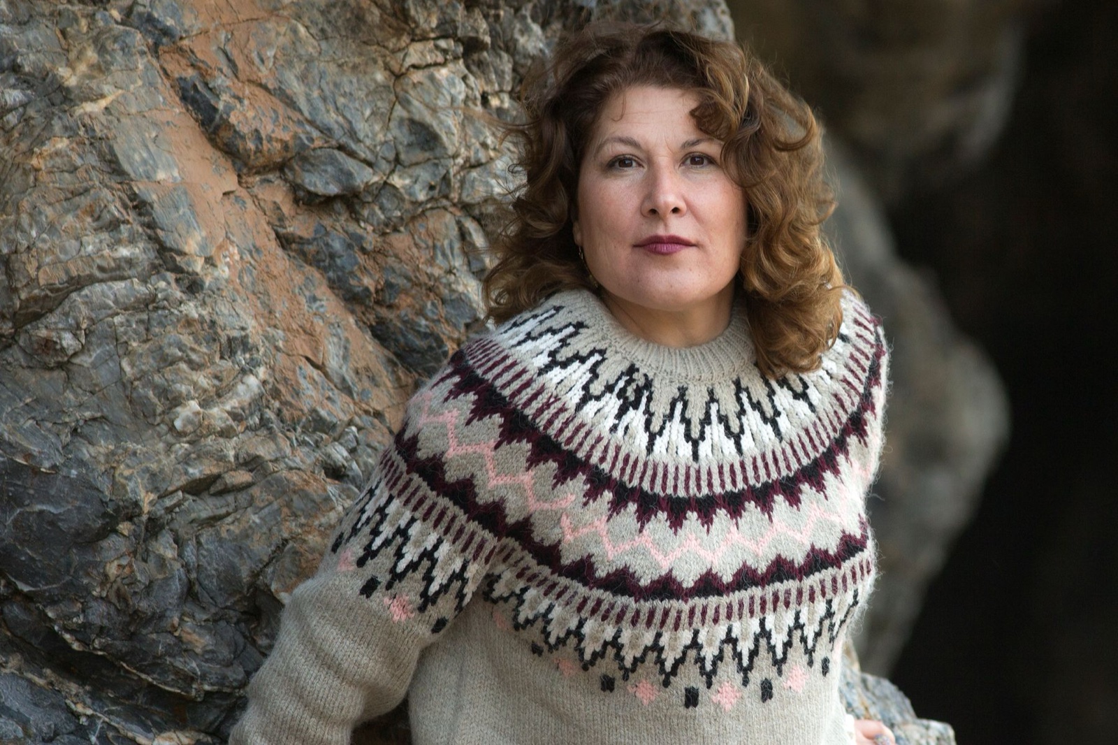 Close-up of a circular sweater yoke worked in bands of cream, black, burgundy and pink stranded colourwork