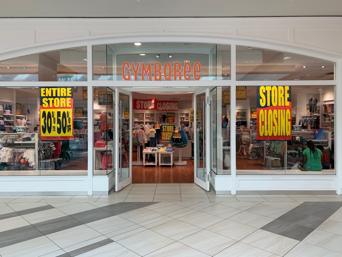 Gymboree mall storefront with Store Closing banners and Entire Store 30 to 50 percent off signs in the windows