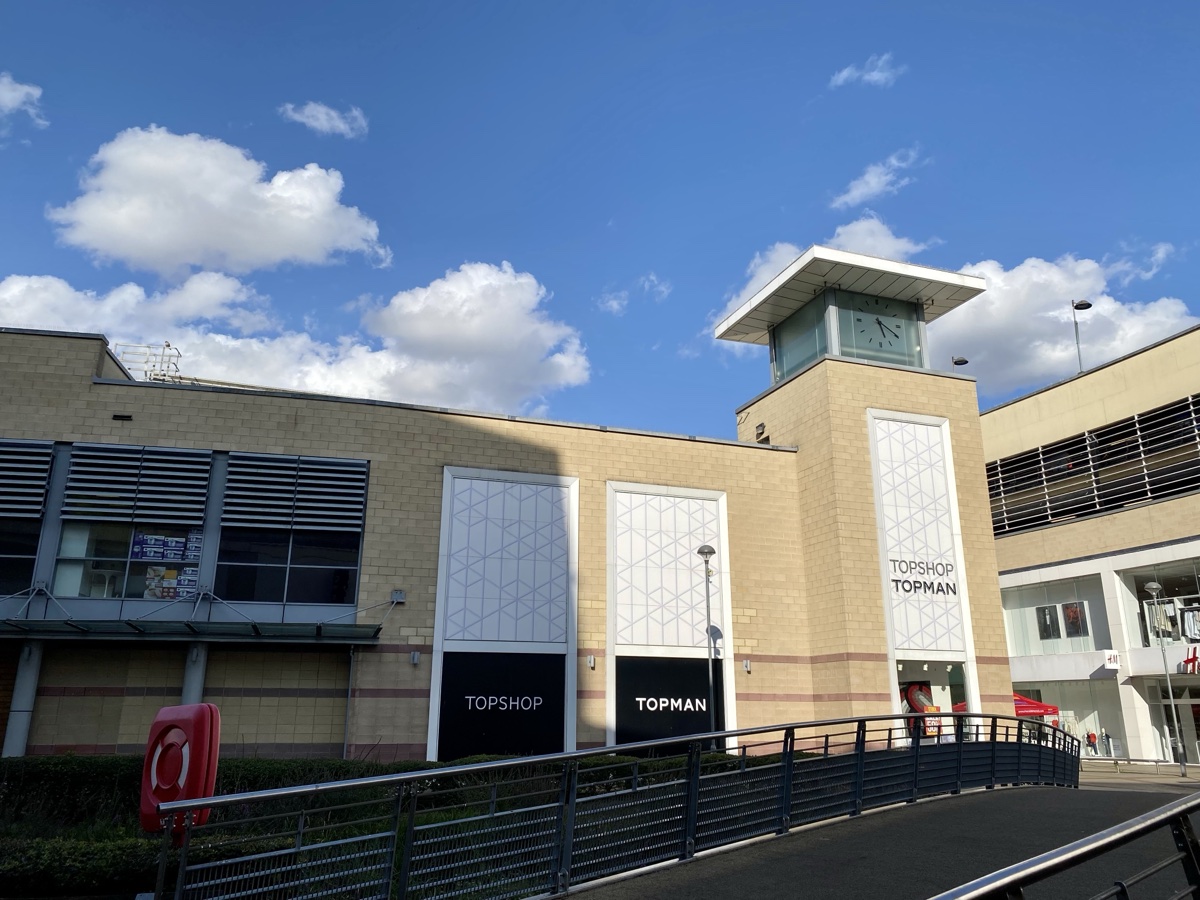 A former Topshop Topman store exterior with signage still up at the Riverside Shopping Centre in Hemel Hempstead under a blue sky, November 2024